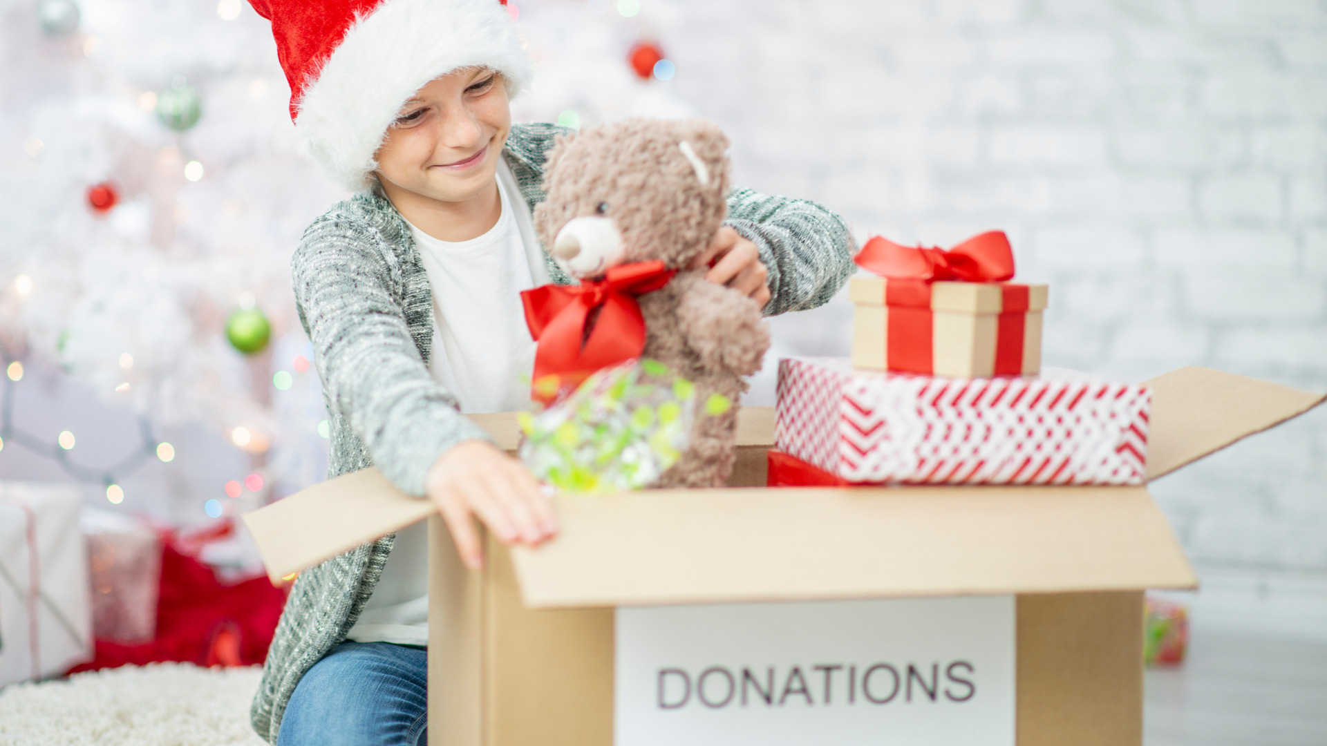 child donating toys for Christmas